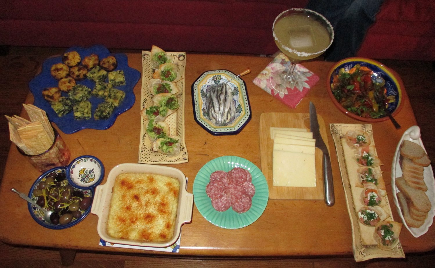 Dinner party: Spinach and cheese squares, mashed potato puffs, white anchovies, fried peppers, truffled cheese, baked artichoke dip, wonton cups filled with either smoked salmon or guacamole.